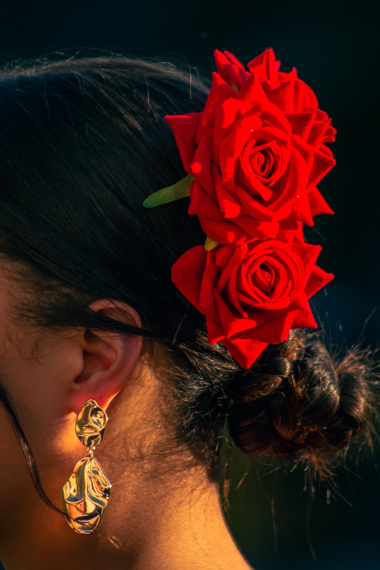 Flamenco dancer with red roses in her hair